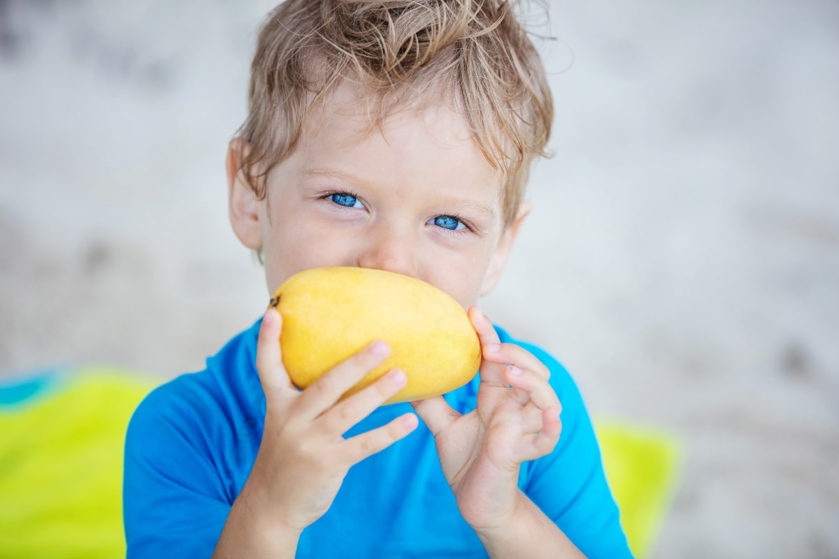 Boy Eating Mango